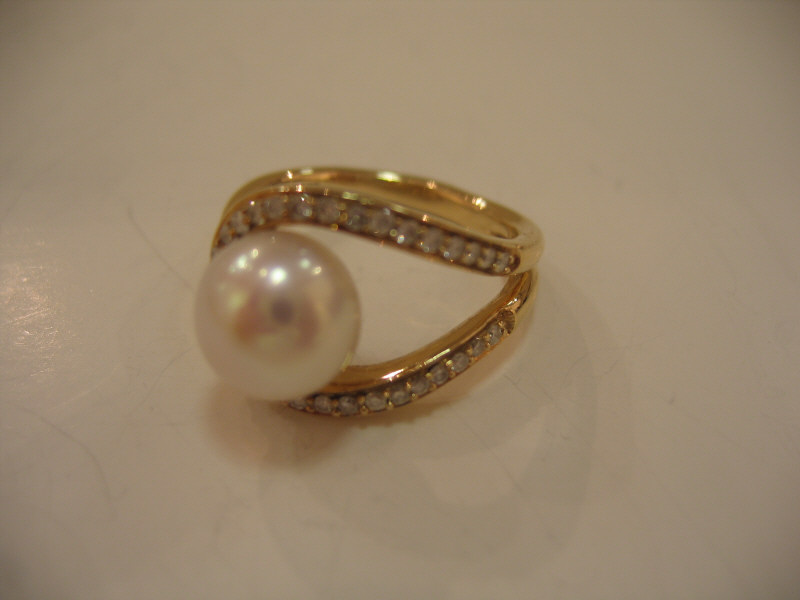 Appraisal: PEARL AND DIAMOND RING k yellow gold open design ring