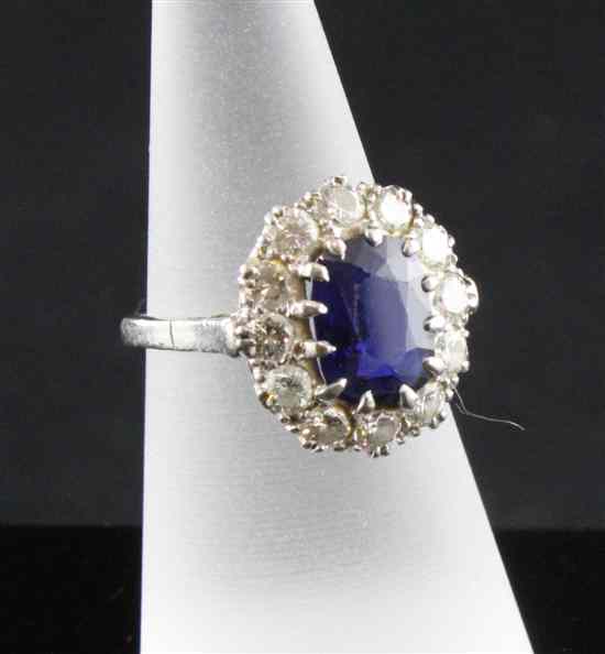 Appraisal: An ct white gold sapphire and diamond oval cluster ring