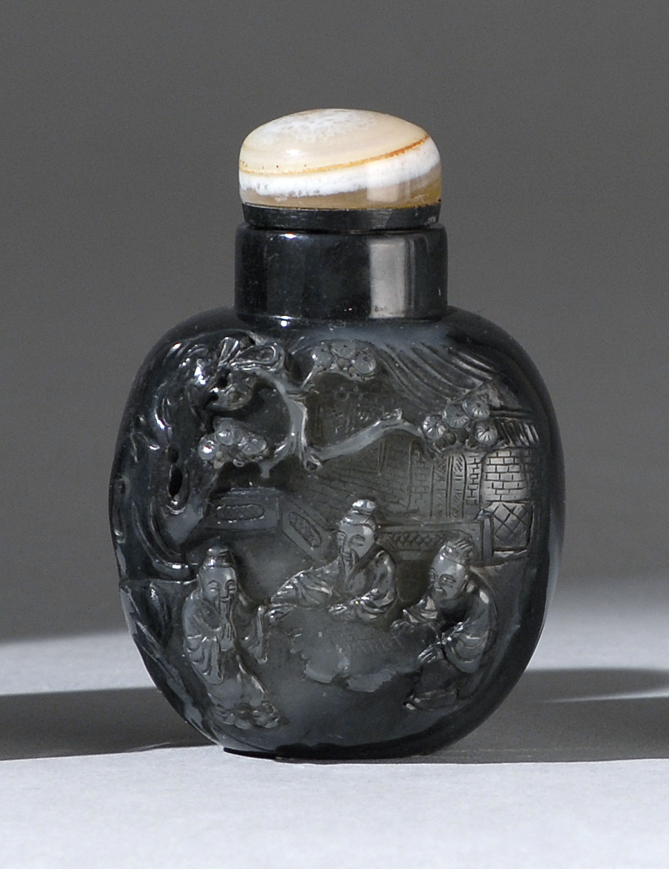 Appraisal: BLACK JADE SNUFF BOTTLE Early th CenturyWith well-hollowed body carved