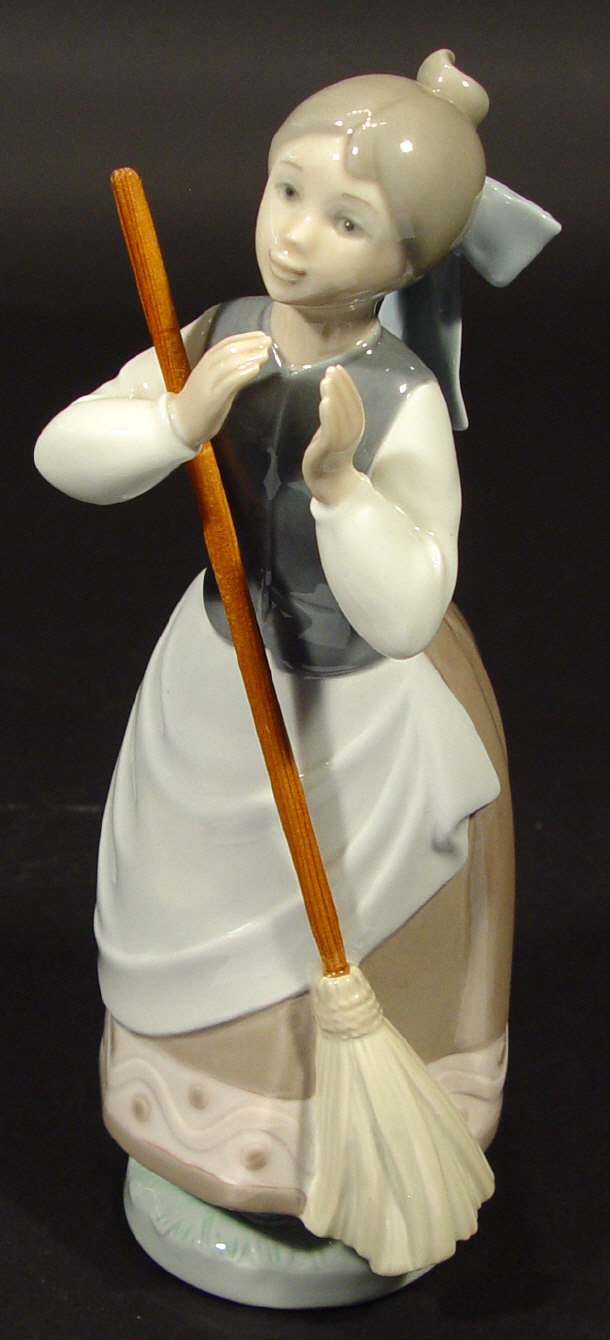 Appraisal: Lladro porcelain figurine clutching a broom with hand painted decoration