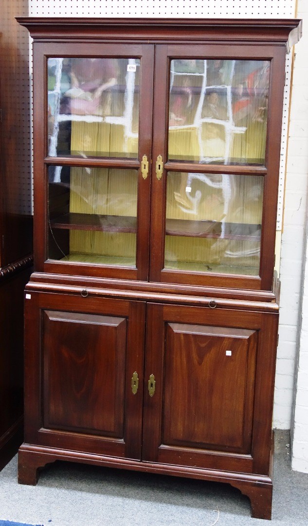 Appraisal: A George III mahogany bookcase cupboard the pair of glazed