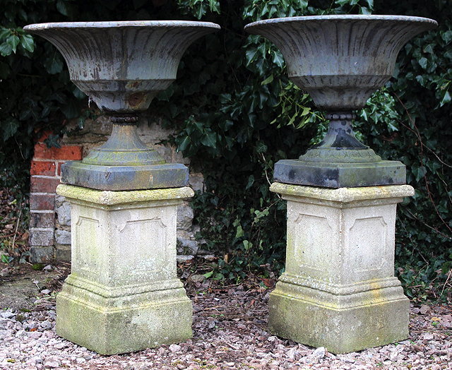 Appraisal: A PAIR OF OLD BLACK PAINTED CAST IRON URNS of