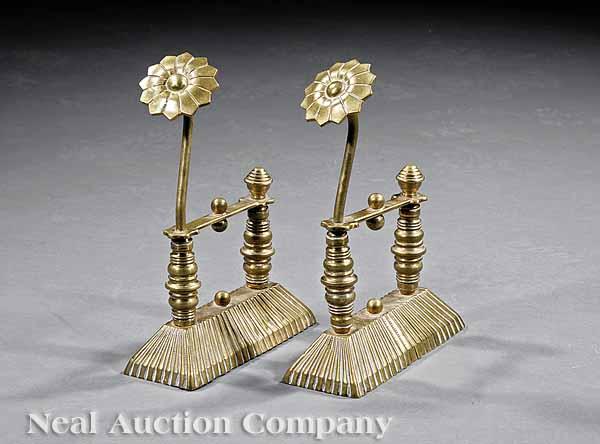 Appraisal: A Pair of English Aesthetic Movement Brass Fireplace Tool Rests