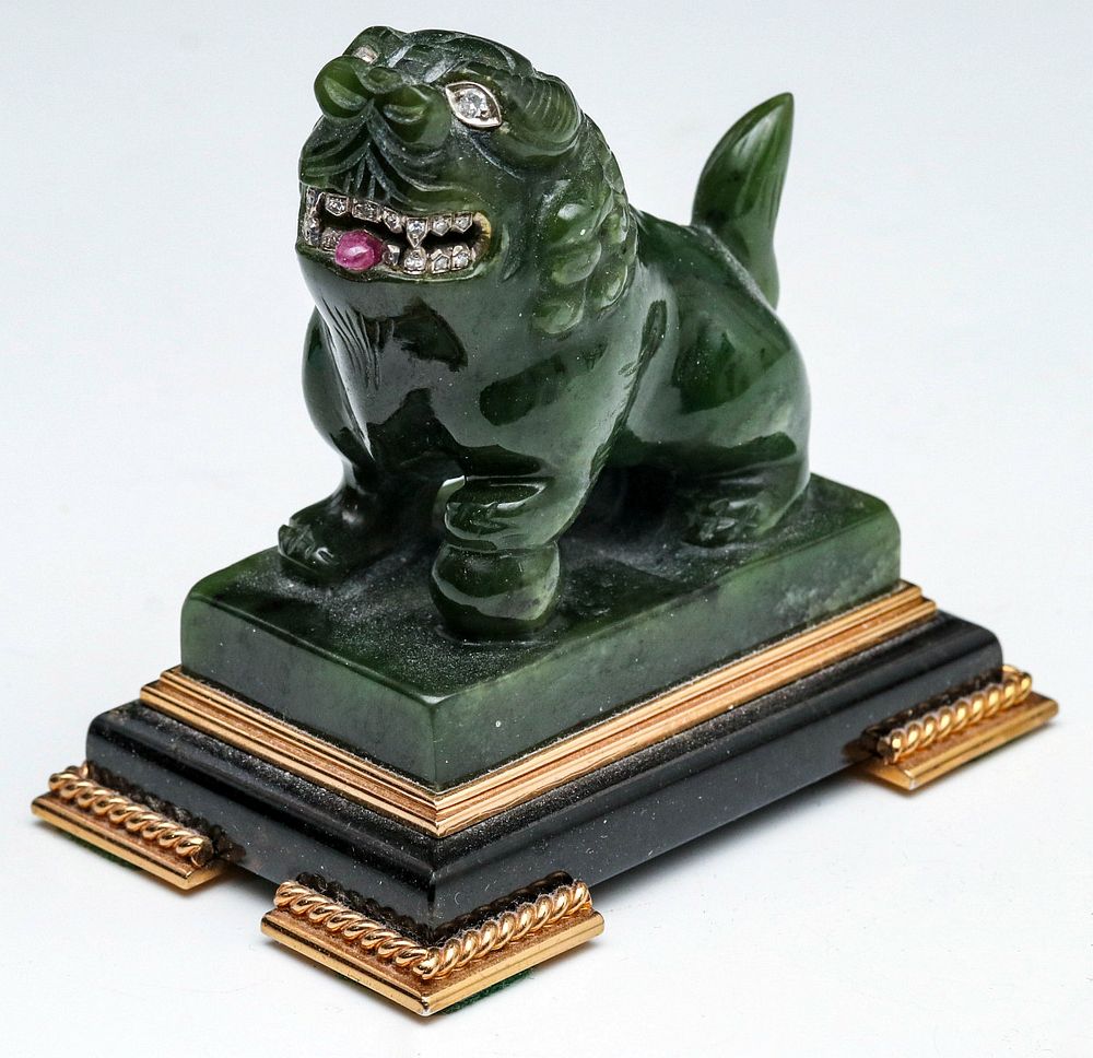 Appraisal: A CARVED JADE FOO DOG WITH DIAMOND EMBELLISHMENTS Nineteen diamonds