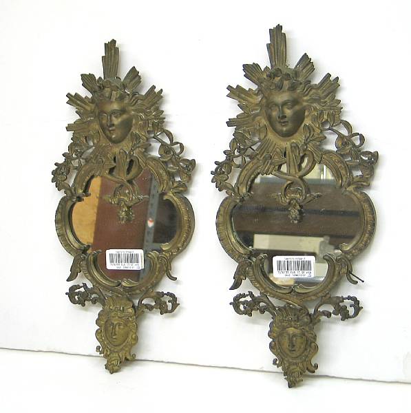 Appraisal: A pair of Louis XV style cast brass mirrors early