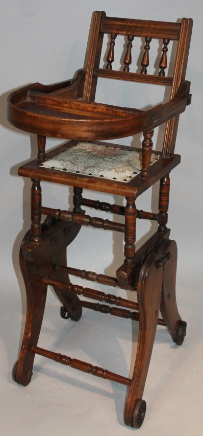 Appraisal: An Edwardian stained beech child's highchair the carved spindle back