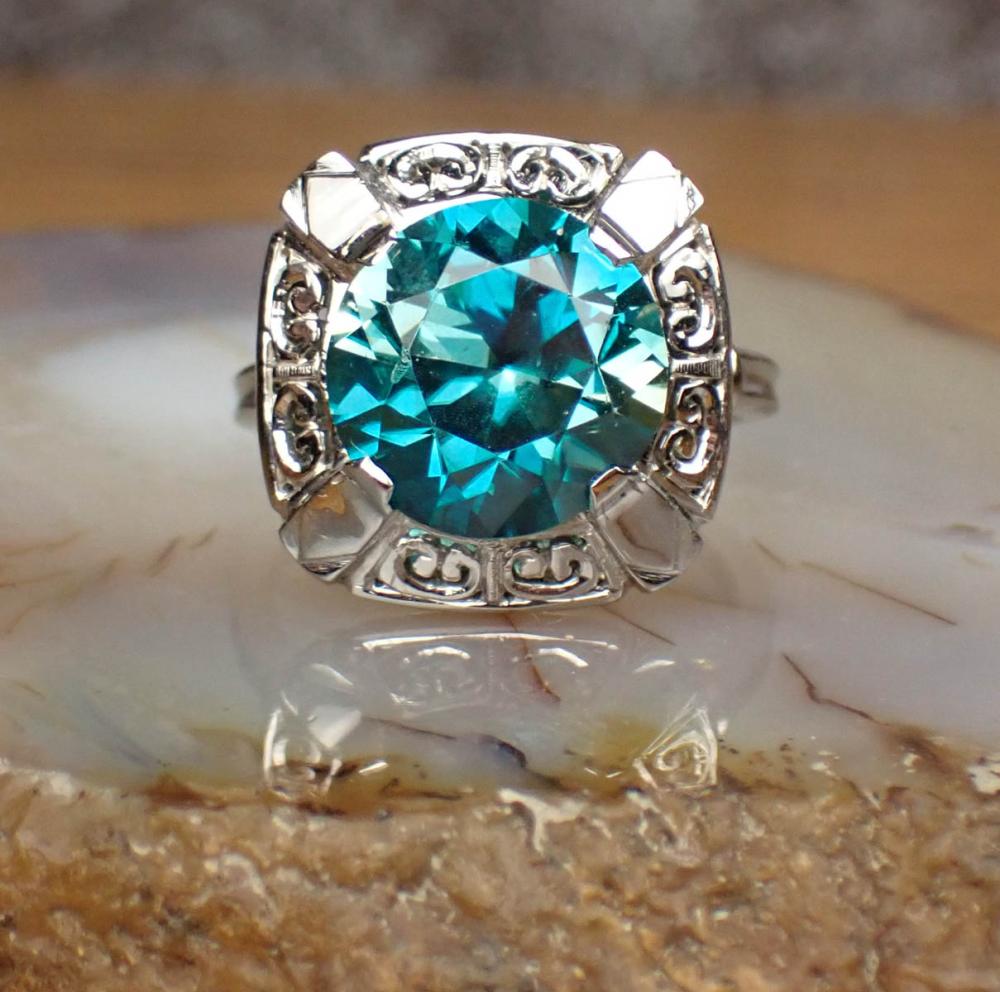 Appraisal: BLUE ZIRCON DIAMOND AND K GOLD RING centering a round-cut