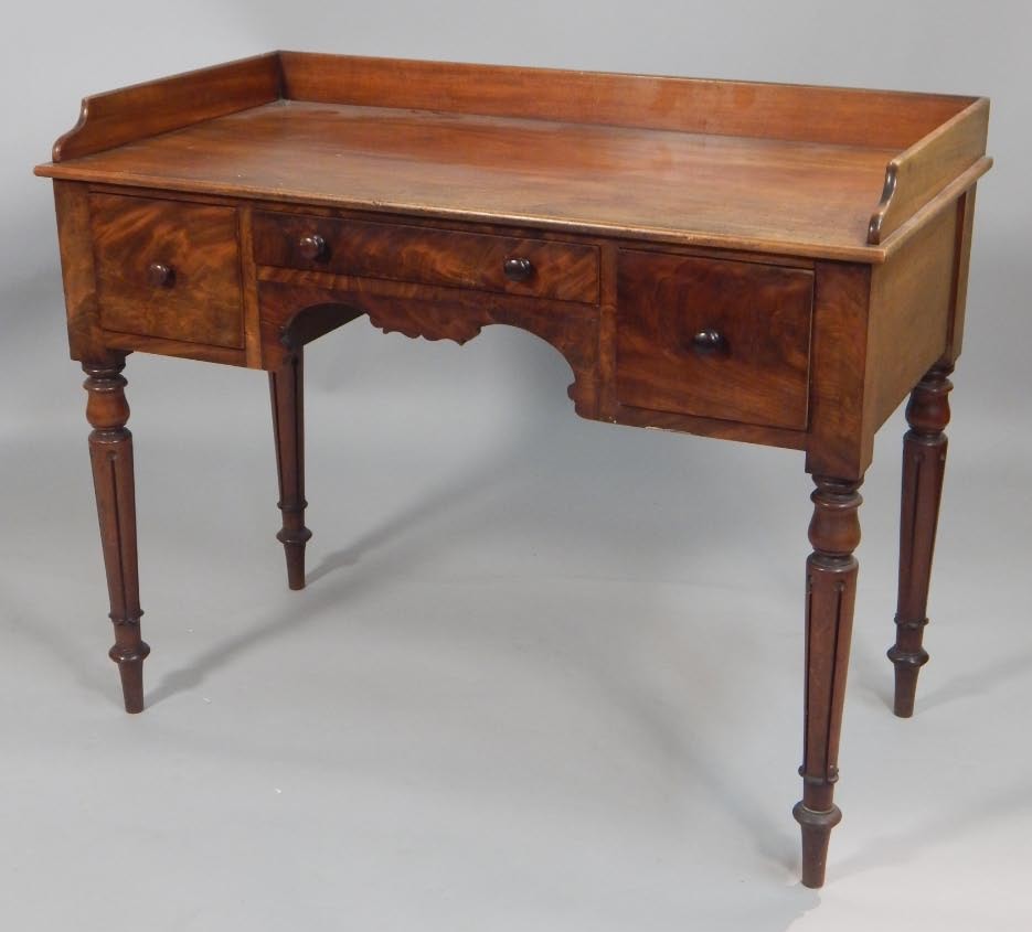 Appraisal: A thC mahogany washstand with a raised back above three