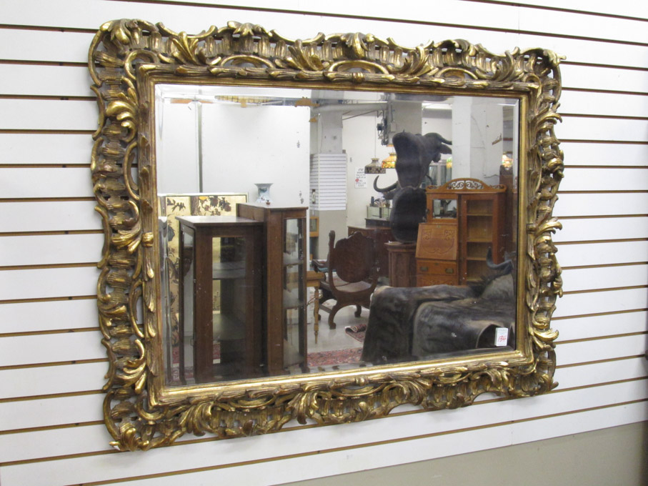 Appraisal: CARVED GILTWOOD FRAMED WALL MIRROR American th century the rectangular