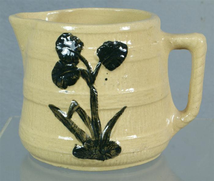 Appraisal: Embossed yellowware milk pitcher with wood barrel brown raised floral