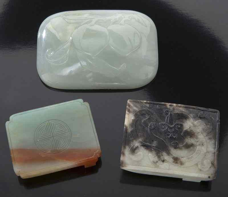 Appraisal: Chinese carved jade belt bucklesdepicting peaches dragons and longevity characters