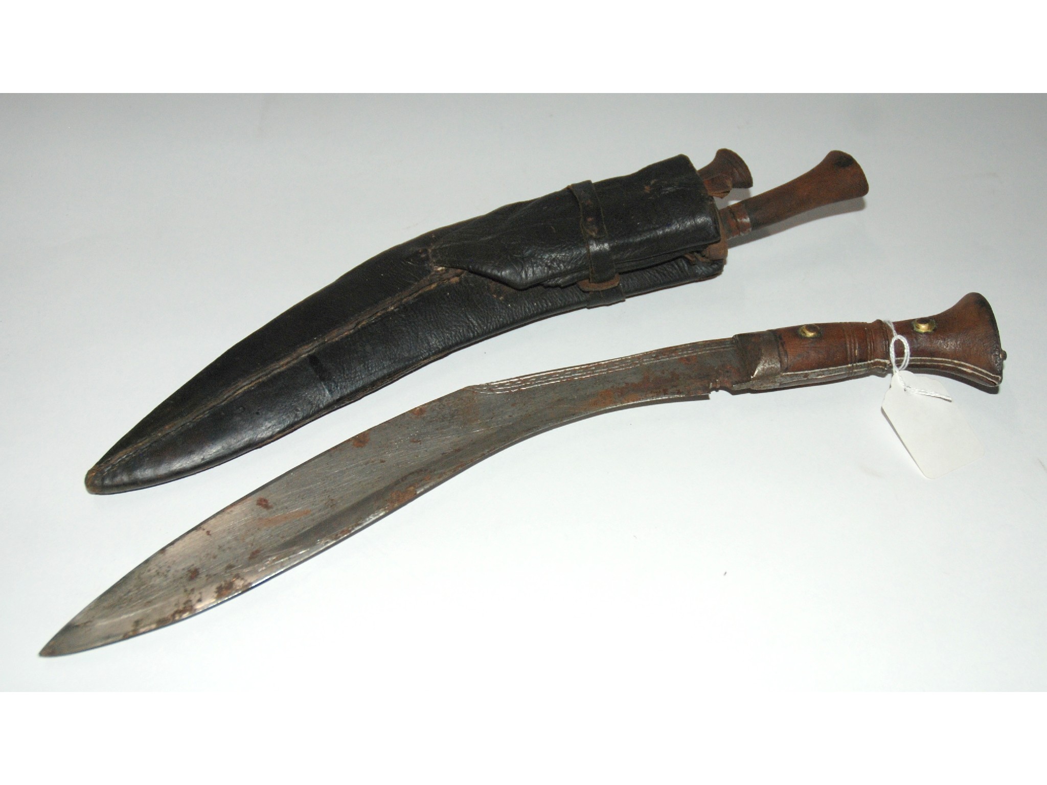 Appraisal: A kukri in leather sheath