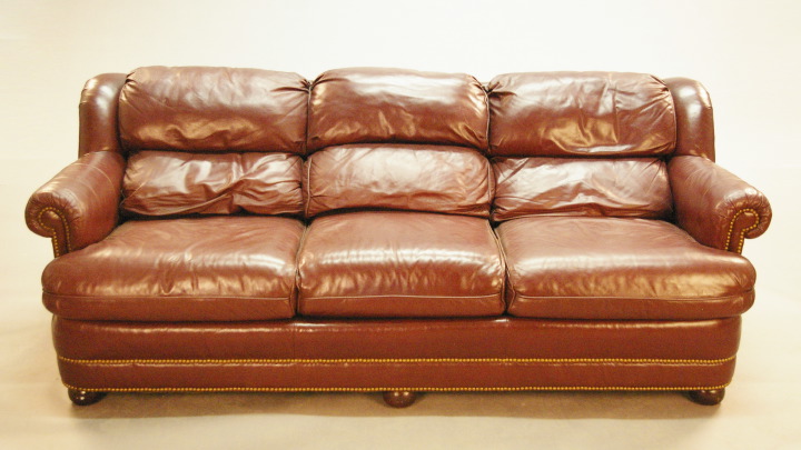 Appraisal: Large Burgundy Leather Triple-Cushion Sofa the back with built-in padded