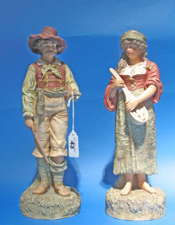 Appraisal: A PAIR OF CONTINENTAL BISQUE PORCELAIN FIGURES of a male