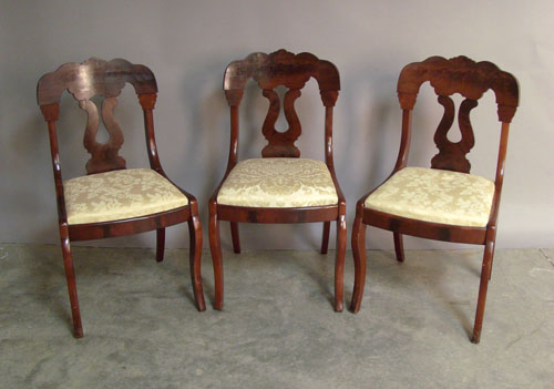 Appraisal: Pair of mahogany saber leg chairs th c together with