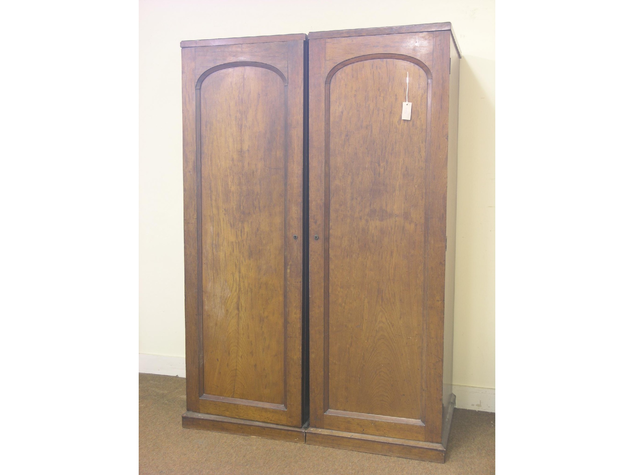 Appraisal: A Victorian mahogany wardrobe enclosed by a pair of domed