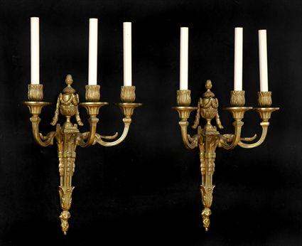 Appraisal: PAIR OF LOUIS XVI-STYLE GILT-METAL THREE-LIGHT WALL APPLIQUES Each tapered