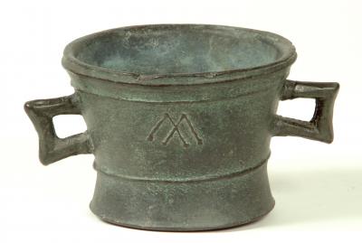 Appraisal: A BRONZE MORTAR with moulded rim twin square loop handles