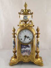 Appraisal: An Italian gilt metal mantel clock with ceramic columns and