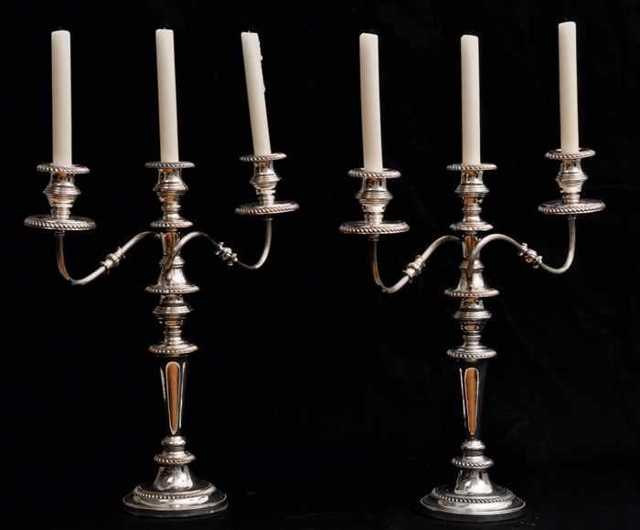 Appraisal: PAIR OF ENGLISH ARMORIAL SILVER-PLATED THREE-LIGHT CANDELABRA With crossed keys