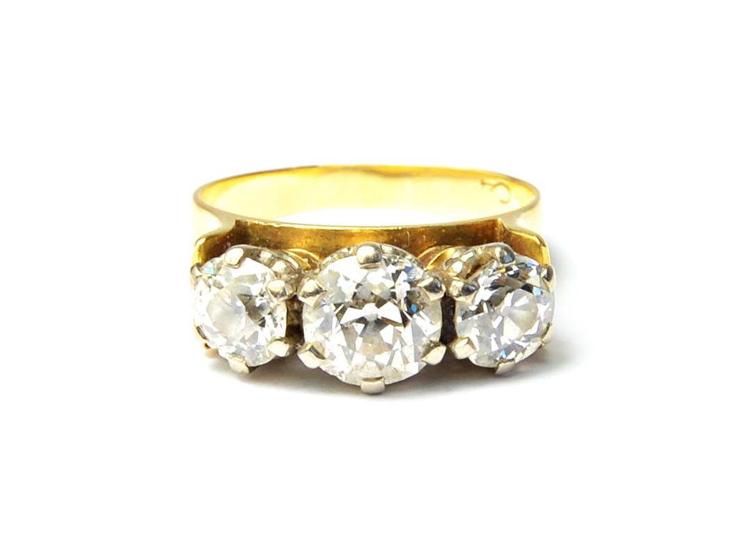 Appraisal: A gold and diamond set three stone ring claw set