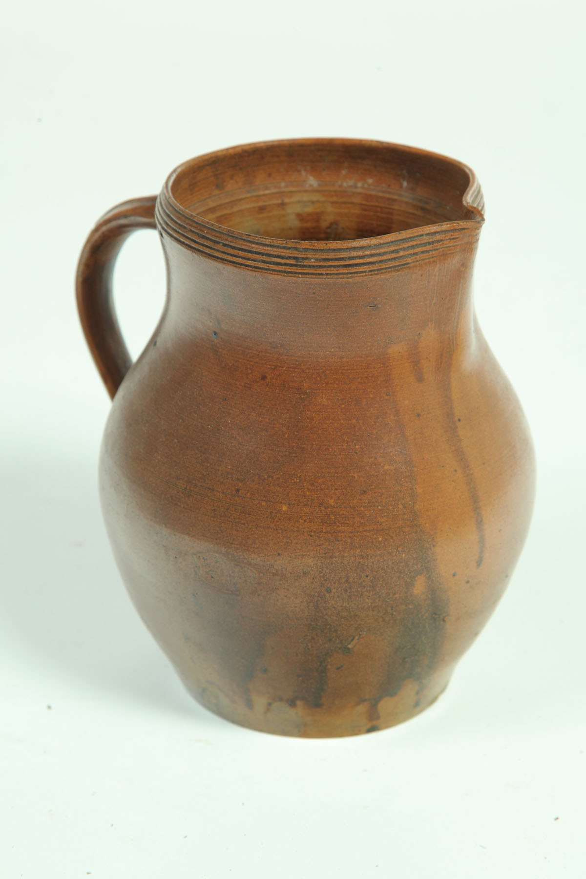 Appraisal: REDWARE PITCHER American mid th century Metallic flecked running glaze