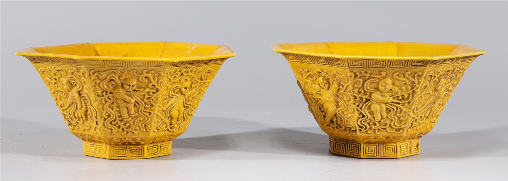 Appraisal: Pair of Chinese yellow ground octagonal faceted porcelain bowls with