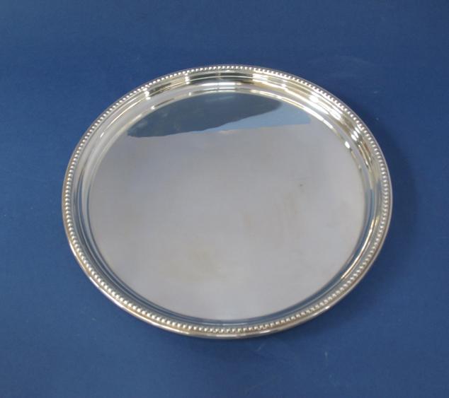 Appraisal: A CARD SALVER of circular form with a raised beaded