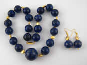 Appraisal: A lapis lazuli bead necklace with matching earrings largest bead