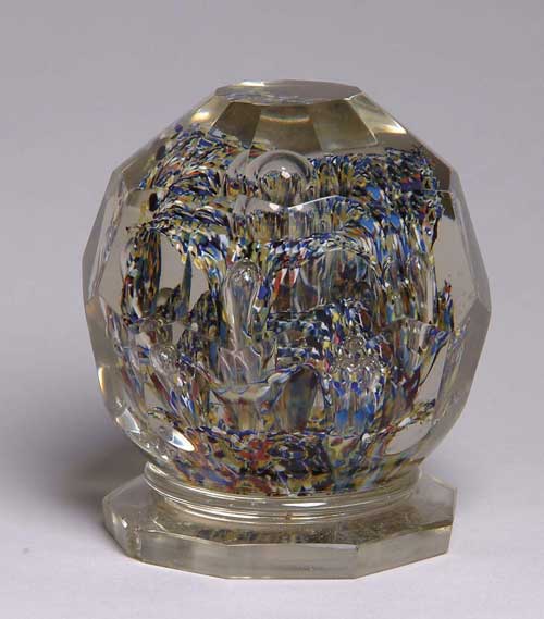 Appraisal: INTERESTING LARGE GLASS PAPERWEIGHT Faceted ball on pedestal in outside