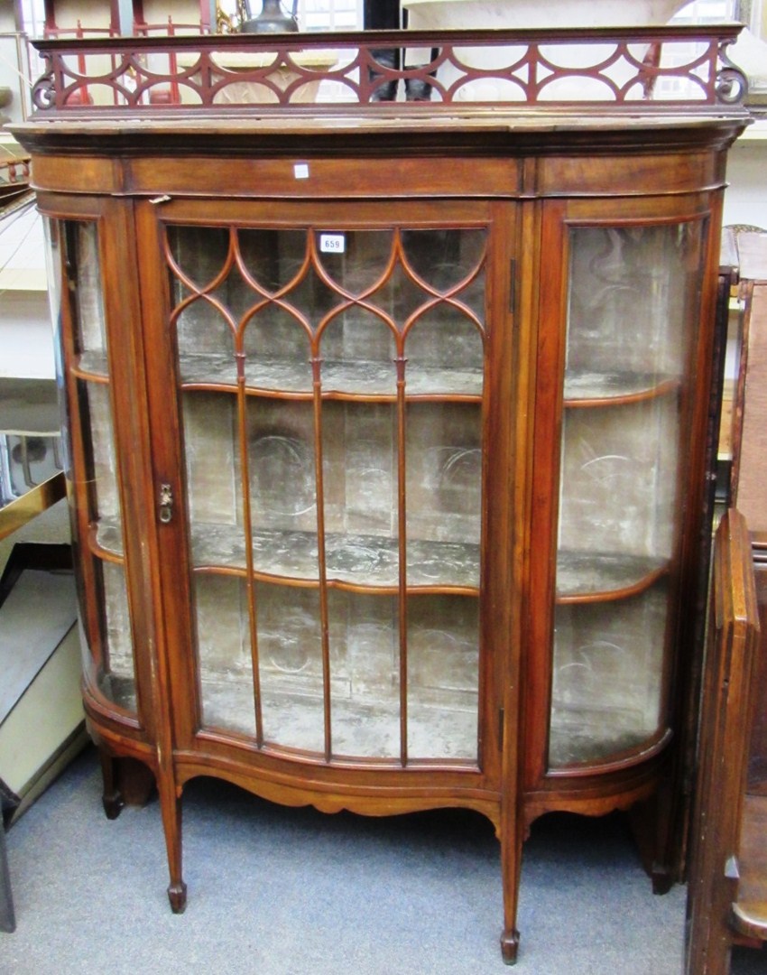 Appraisal: An early th century mahogany display cabinet with serpentine door