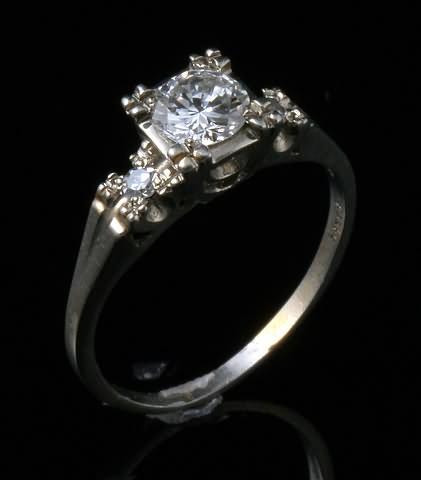 Appraisal: KW mm round diamond Accented by mm round single cut