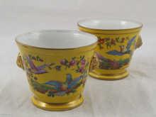 Appraisal: A pair of ceramic cachepots in yellow with decorative vignettes