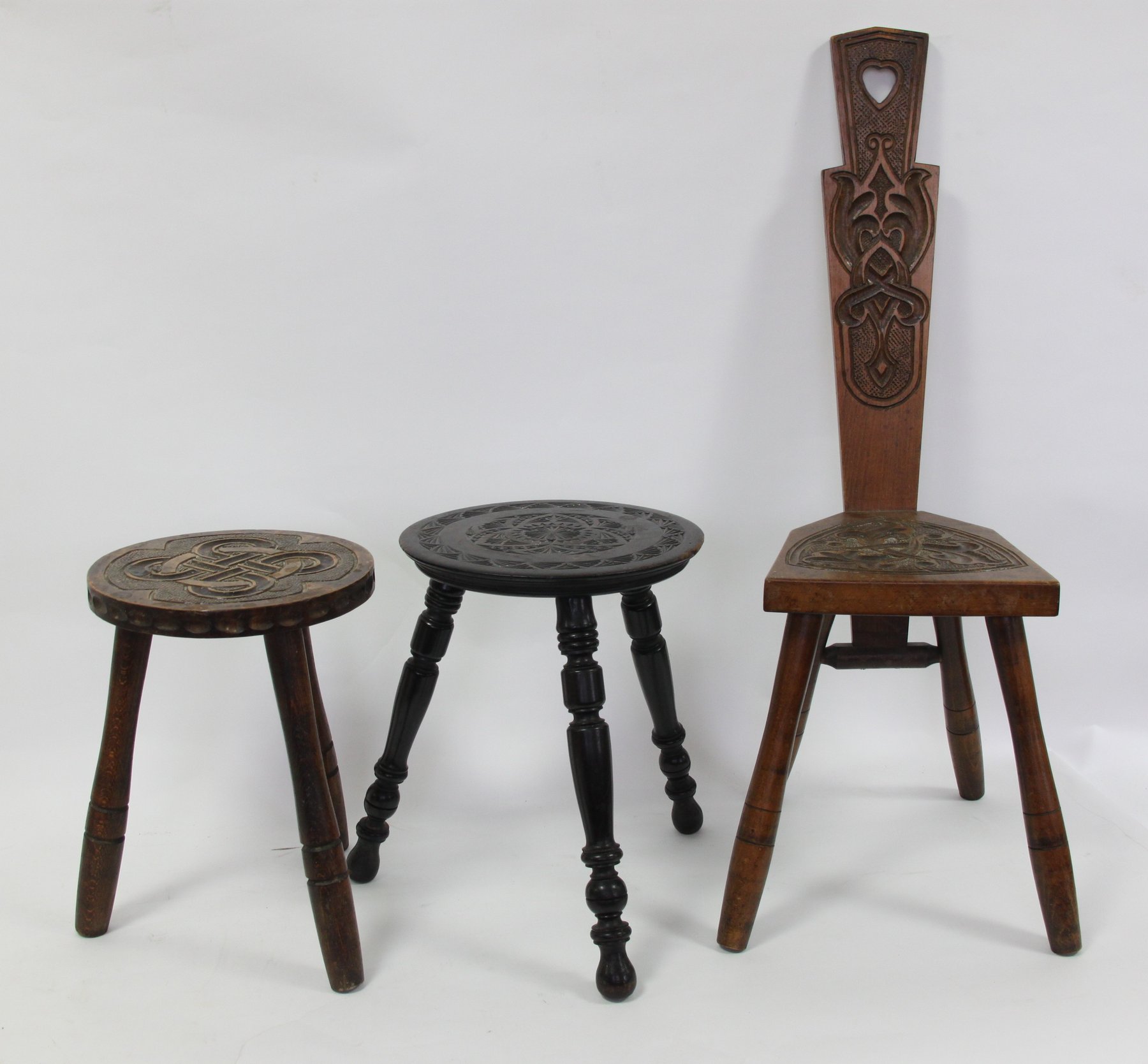 Appraisal: A turned wood spinning wheel a carved chair and stool