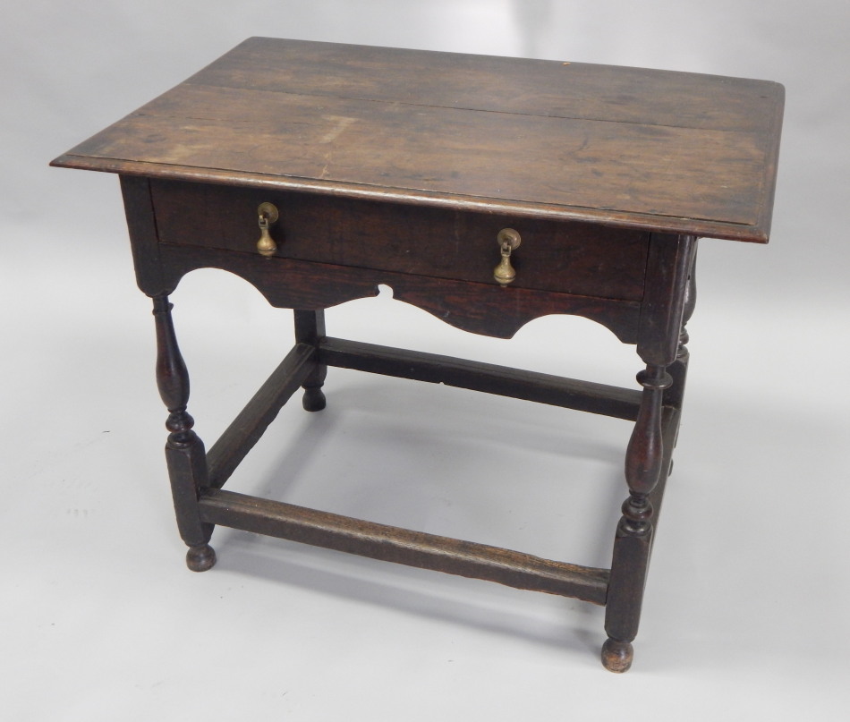 Appraisal: An oak side table the rectangular planked top with a