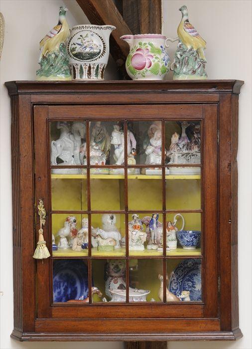 Appraisal: GEORGE III WALNUT HANGING CORNER CUPBOARD The molded top over