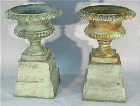 Appraisal: PAIR OF GREEN PATINATED URNS ON STANDS The urns with