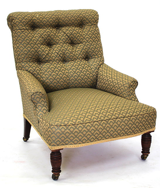 Appraisal: AN OLD BUTTON UPHOLSTERED ARMCHAIR with ring turned tapering front