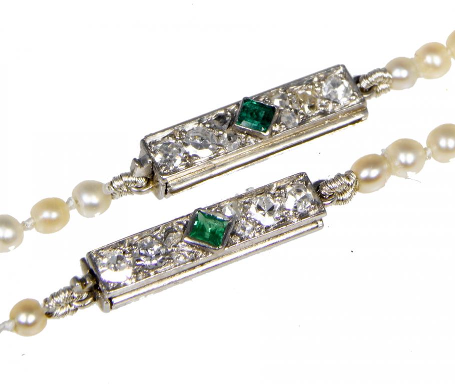 Appraisal: A PAIR OF PEARL NECKLACES with rectangular emerald and diamond