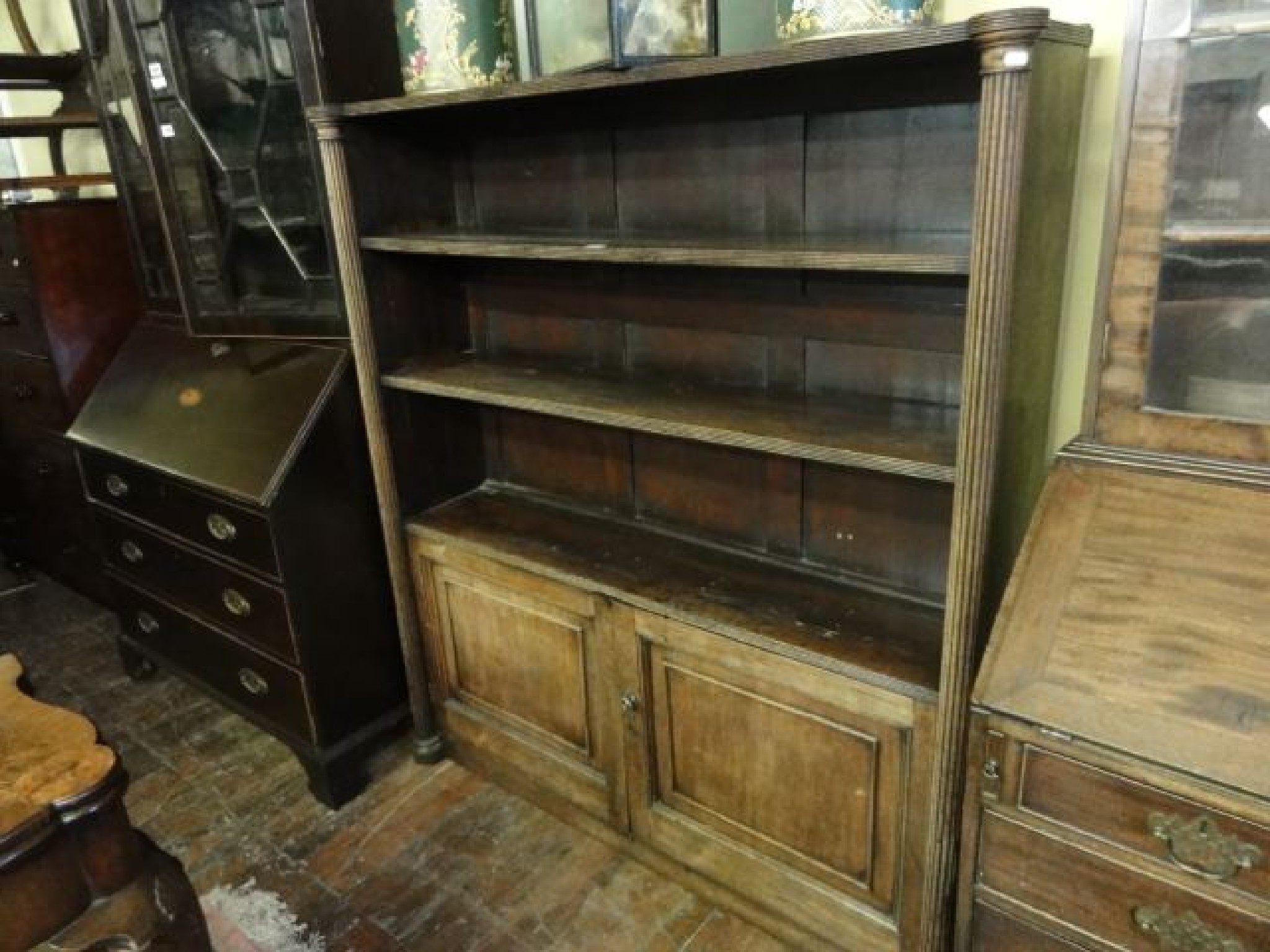 Appraisal: A th century mahogany freestanding bookcase with two fixed open