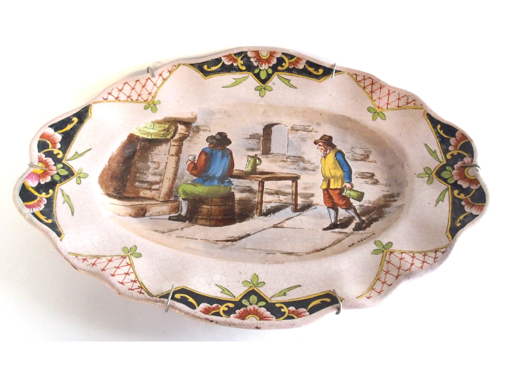 Appraisal: A French pottery oval shaped platter painted with a tavern