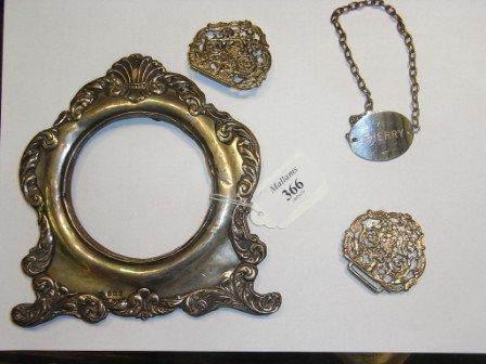 Appraisal: A SILVER PHOTO FRAME a silver sherry decanter label and