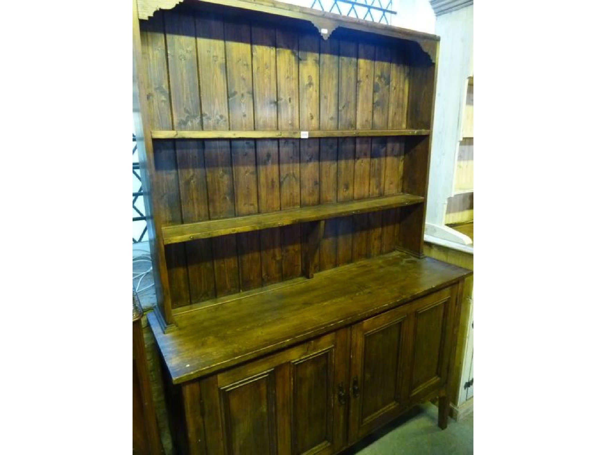 Appraisal: A stained pine kitchen dresser the base enclosed by a