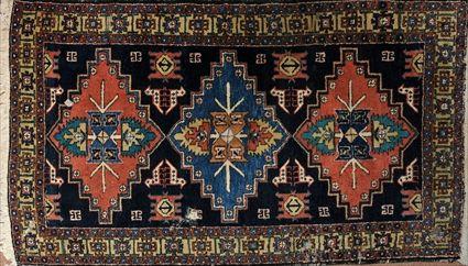 Appraisal: ORIENTAL CARPET The rectangular dark blue field with three geometric