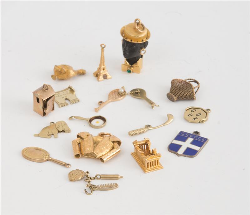 Appraisal: GROUP OF GOLD AND SILVER CHARMS Of various designs grams