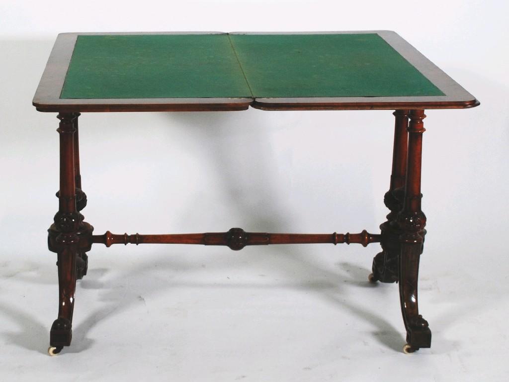 Appraisal: MID VICTORIAN CARVED FIGURED WALNUTWOOD FOLD OVER CARD TABLE the