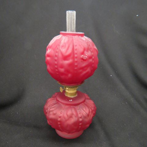 Appraisal: Miniature Art Glass Oil Lamp satin ruby puffed drapery style