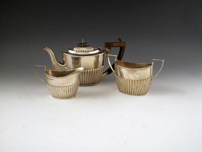 Appraisal: An Edwardian silver three-piece bachelor's silver tea set by W