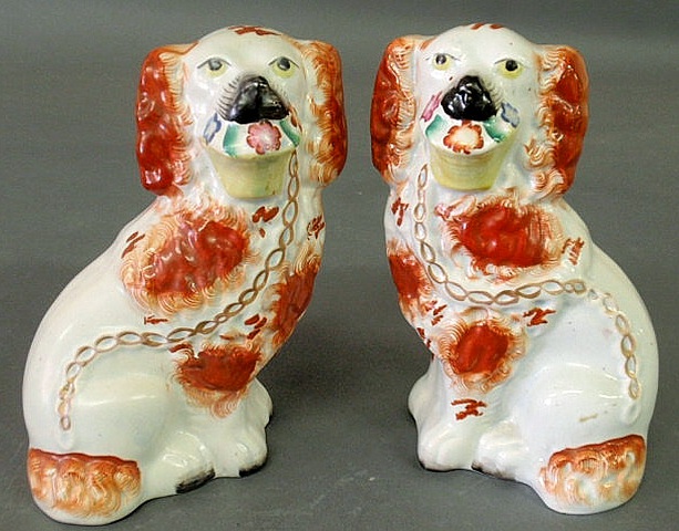 Appraisal: Pair of Staffordshire red and white seated spaniels holding baskets