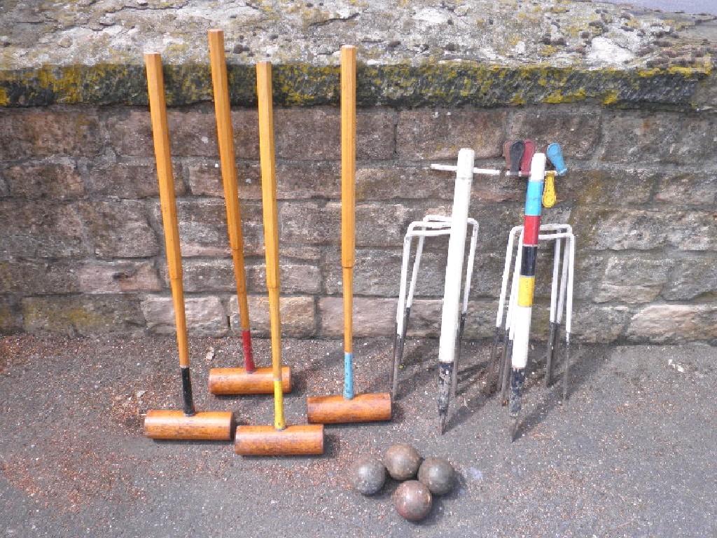 Appraisal: A thC croquet set comprising four mallets balls hoops markers